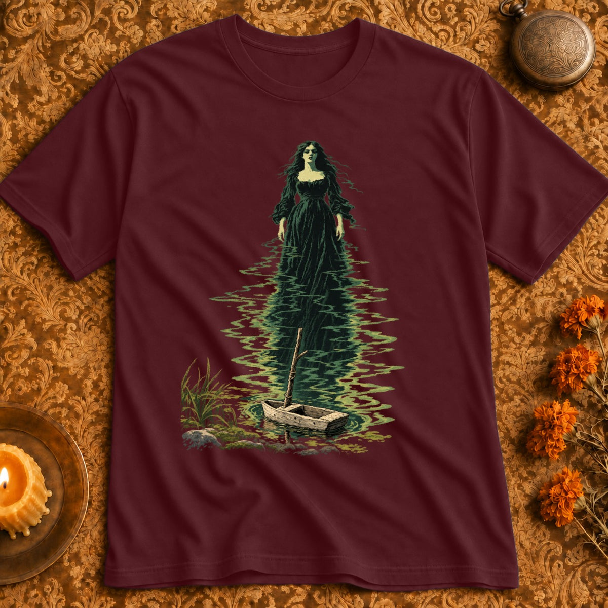 T-shirt features spooky woman in black dress standing in water by a rowboat.
