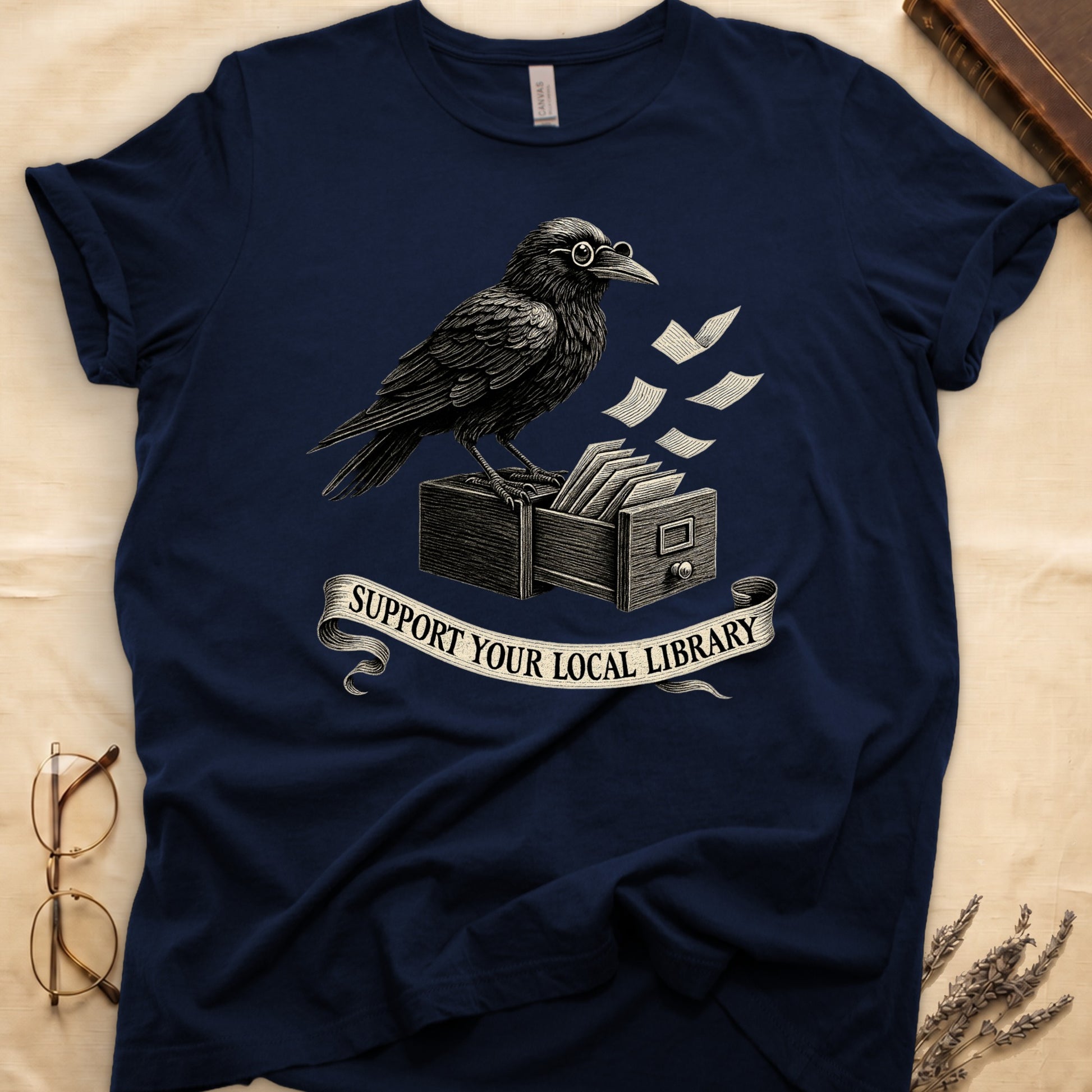 Black tee with raven writing on "823.4" parchment by candlelight, ink jar beside, "MIDNIGHT CATALOGUER" banner above.