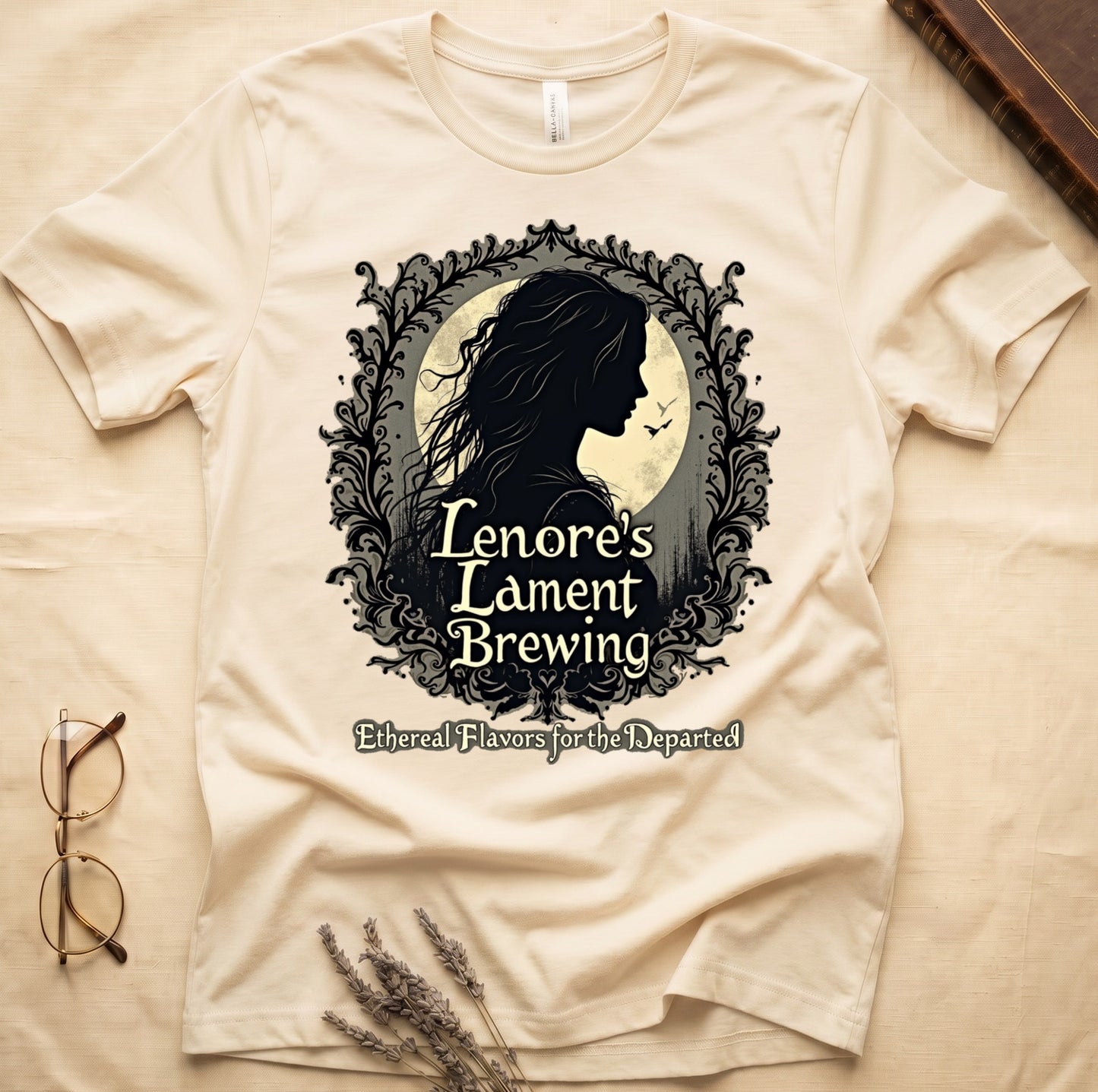Natural tee with sage label, Lenore silhouette and moon, "Lenore's Lament Brewing," "Ethereal Flavors for the Departed."