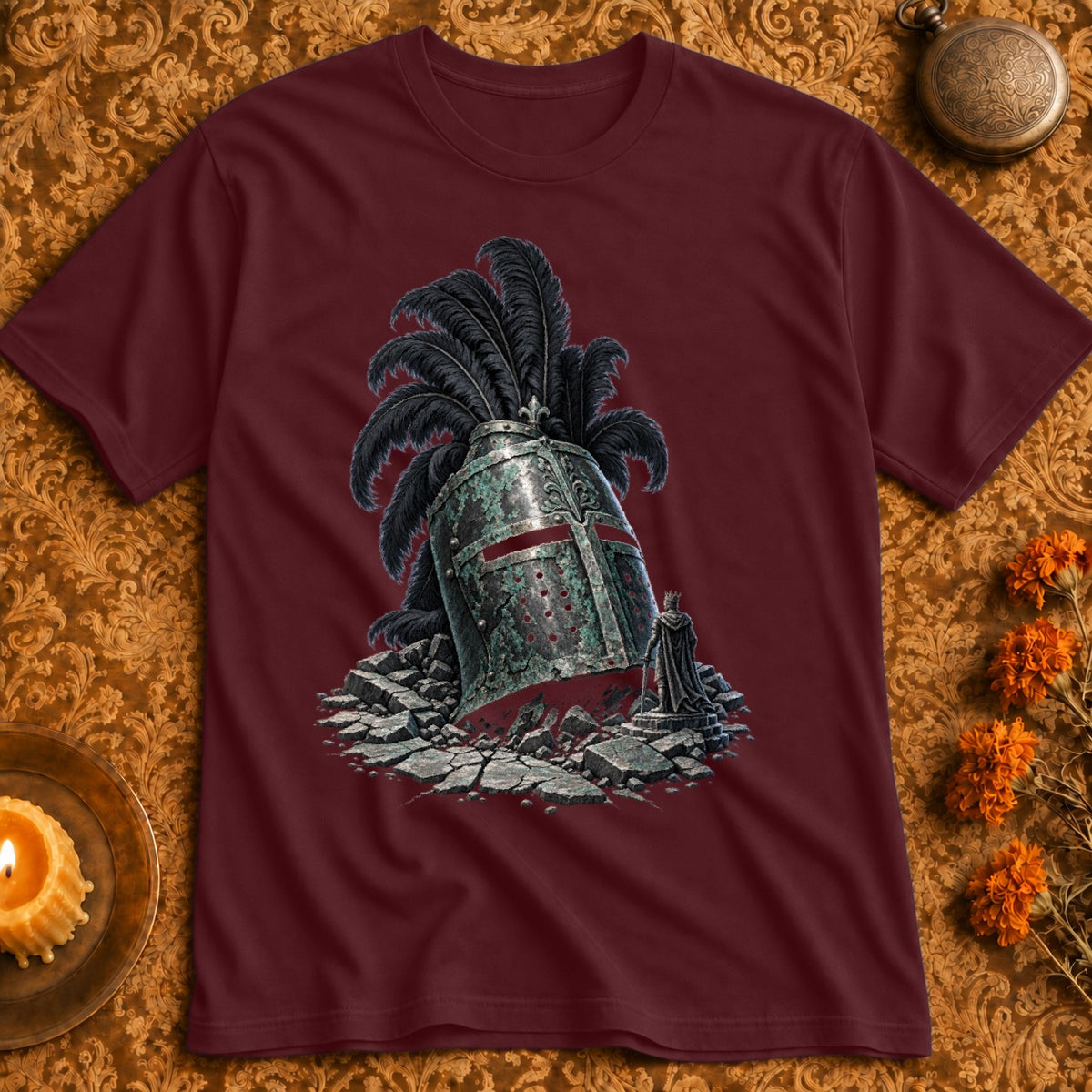 Maroon t-shirt featuring a graphic of a weathered, feathered knight's helmet amidst rubble.