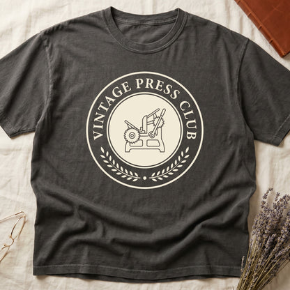 Pepper tee with circular letterpress badge, "VINTAGE PRESS CLUB" in serif capitals, antique printing press in cream linework.