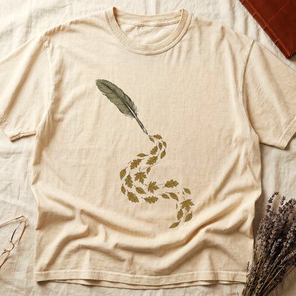 Ivory tee with antique quill pen in cream linework, oak and maple leaves cascading from the nib in gold and green.