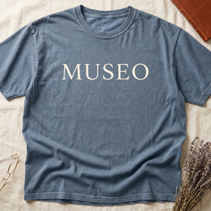 Blue Jean tee with "MUSEO" in oversized cream serif capitals, minimalist typographic design.