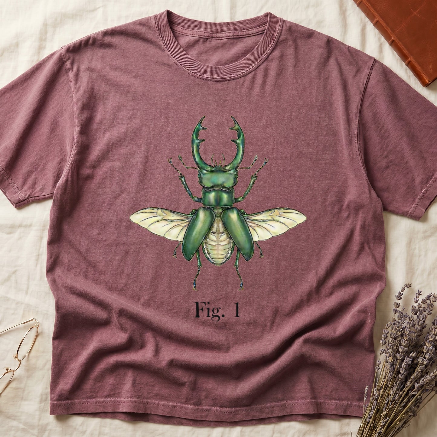 Muted rose t-shirt with green stag beetle illustration and text "Fig. 1".
