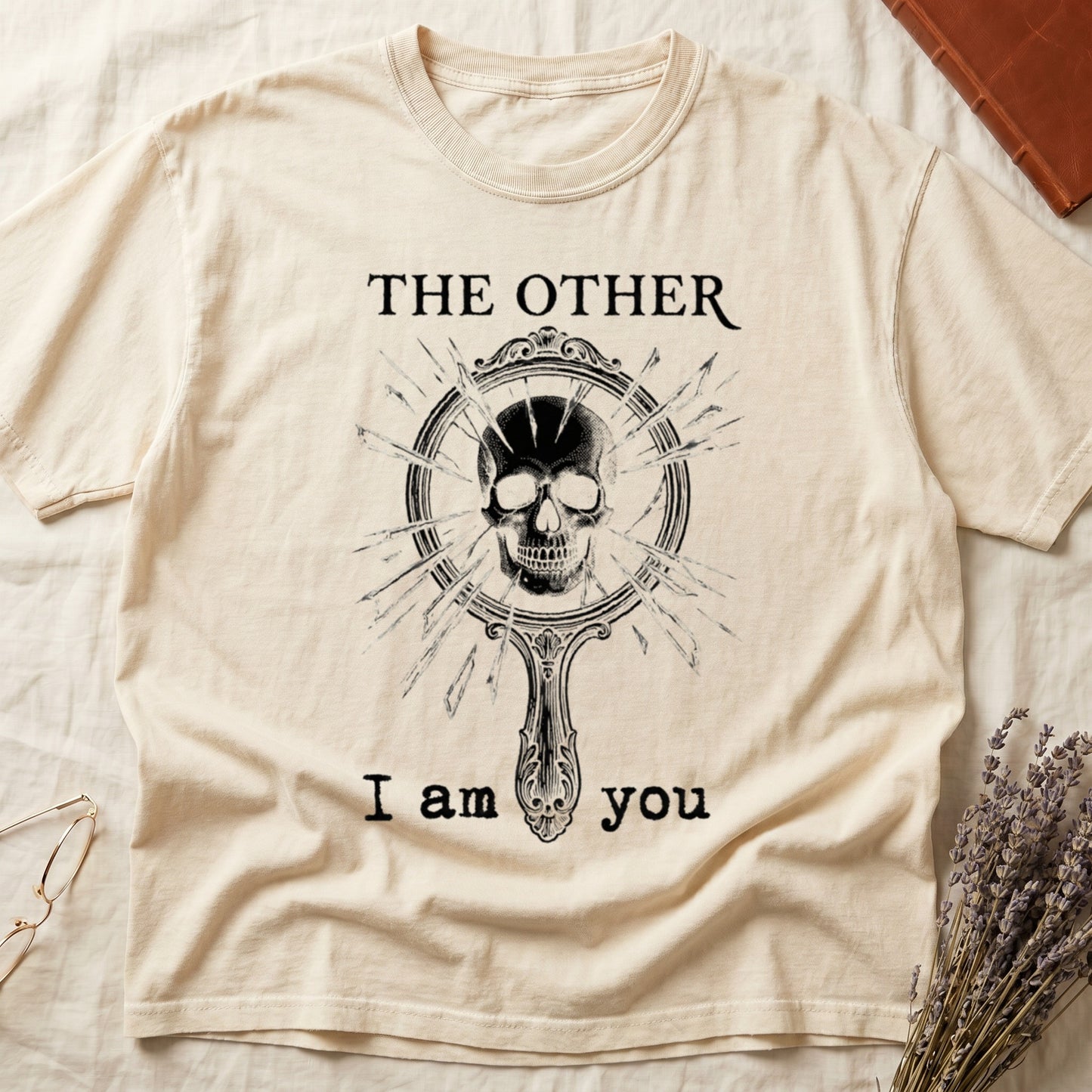 Ivory tee with shattered mirror and skull emerging in cream linework, "THE OTHER" top, "I am you" below.