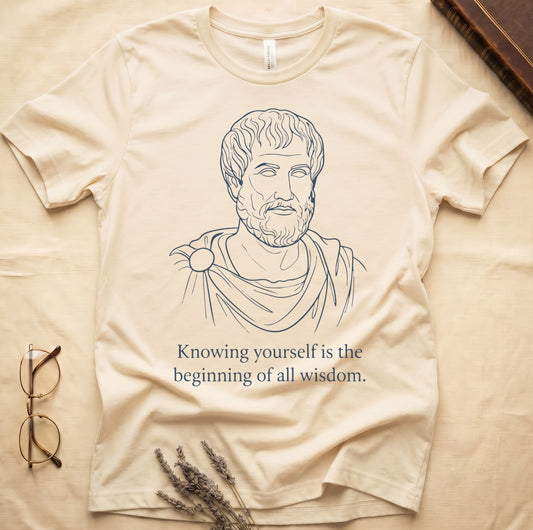 Natural tee with classical philosopher bust in cream linework, "Knowing yourself is the beginning of all wisdom" below.