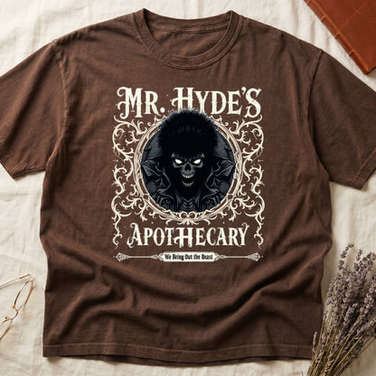 Black tee with ornate filigree frame, wild-haired skull figure, "MR. HYDE'S APOTECARY," "We Bring Out the Beast" below.