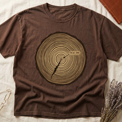 Espresso tee with cross-section of tree rings in warm brown, arrow pointing to center labeled "YEAR ONE" in serif type.