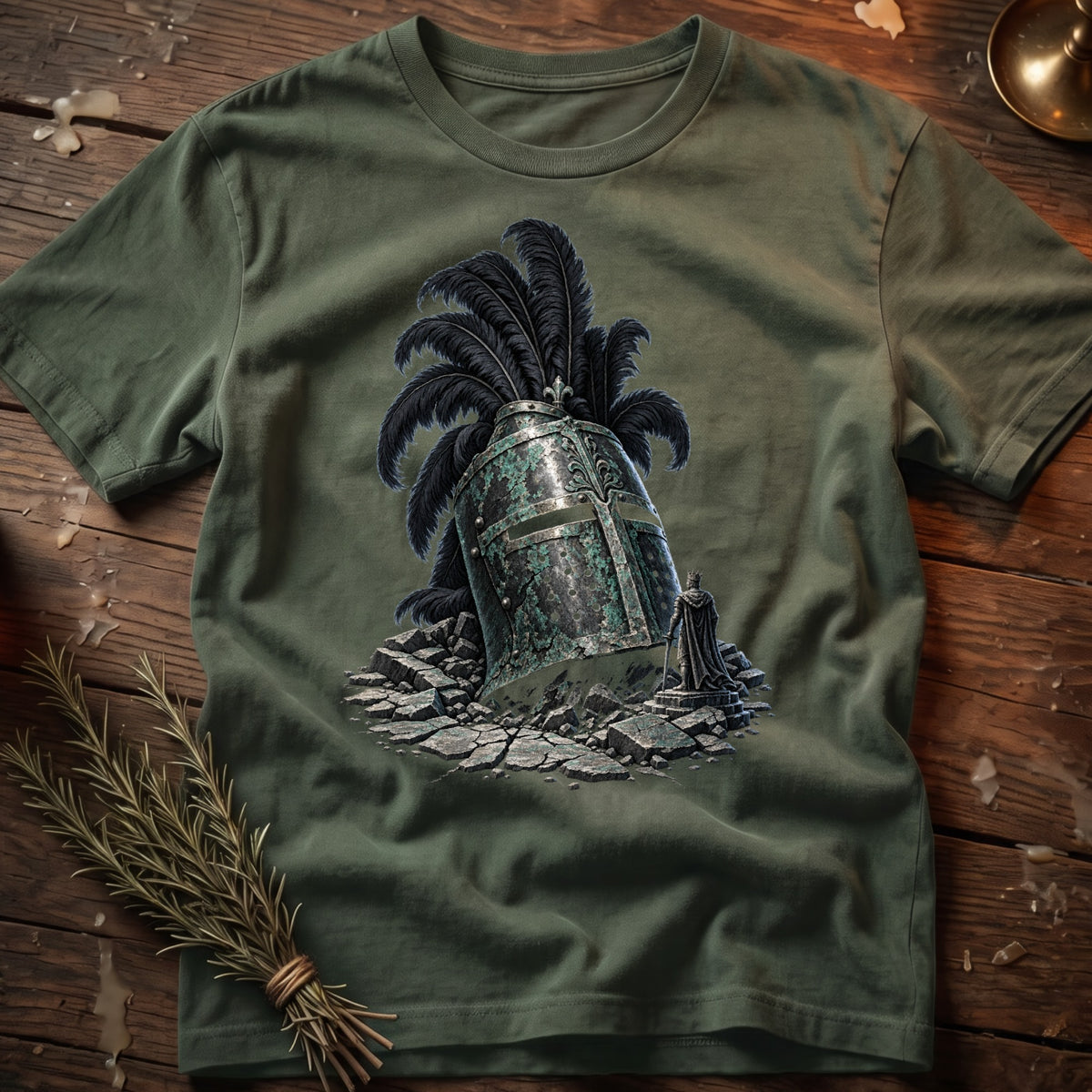 Green t-shirt with a graphic of a fallen knight's helmet with black plumes and a small king statue.