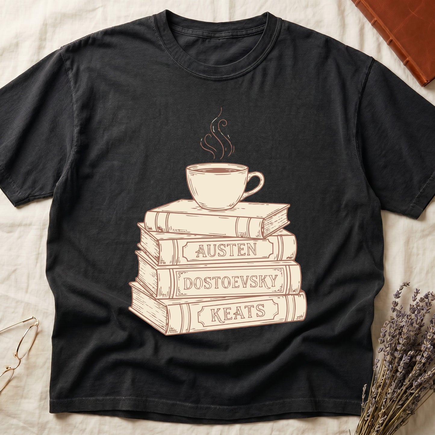 Black tee with stack of vintage books labeled "AUSTEN," "DOSTOEVSKY," "KEATS" topped with a steaming coffee cup.