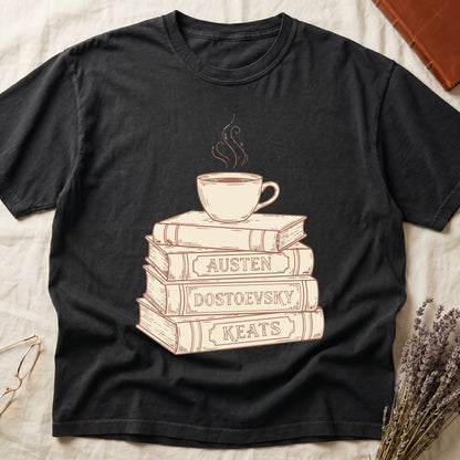 Black tee with stack of vintage books labeled "AUSTEN," "DOSTOEVSKY," "KEATS" topped with a steaming coffee cup.