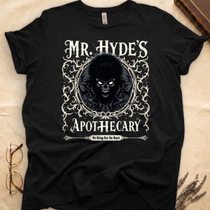 Military Green tee with ornate filigree frame, wild-haired skull figure, "MR. HYDE'S APOTECARY," "We Bring Out the Beast" below.