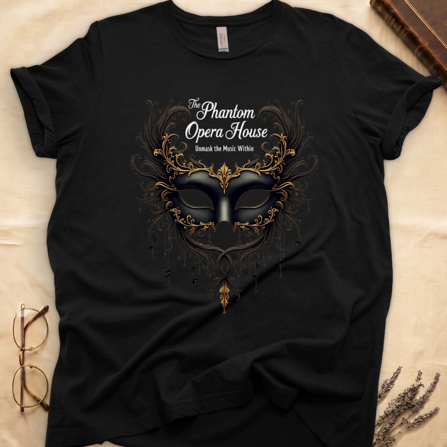 Black tee with gold-and-black masquerade mask, scrollwork wings, "The Phantom Opera House," "Unmask the Music Within."
