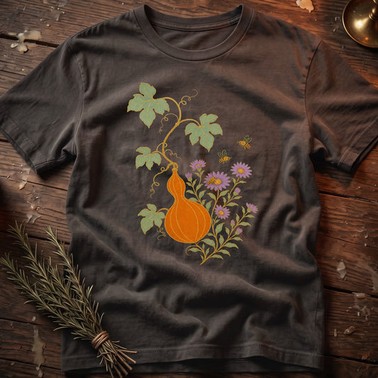 Dark gray t-shirt with an orange gourd, purple flowers, and bees design.