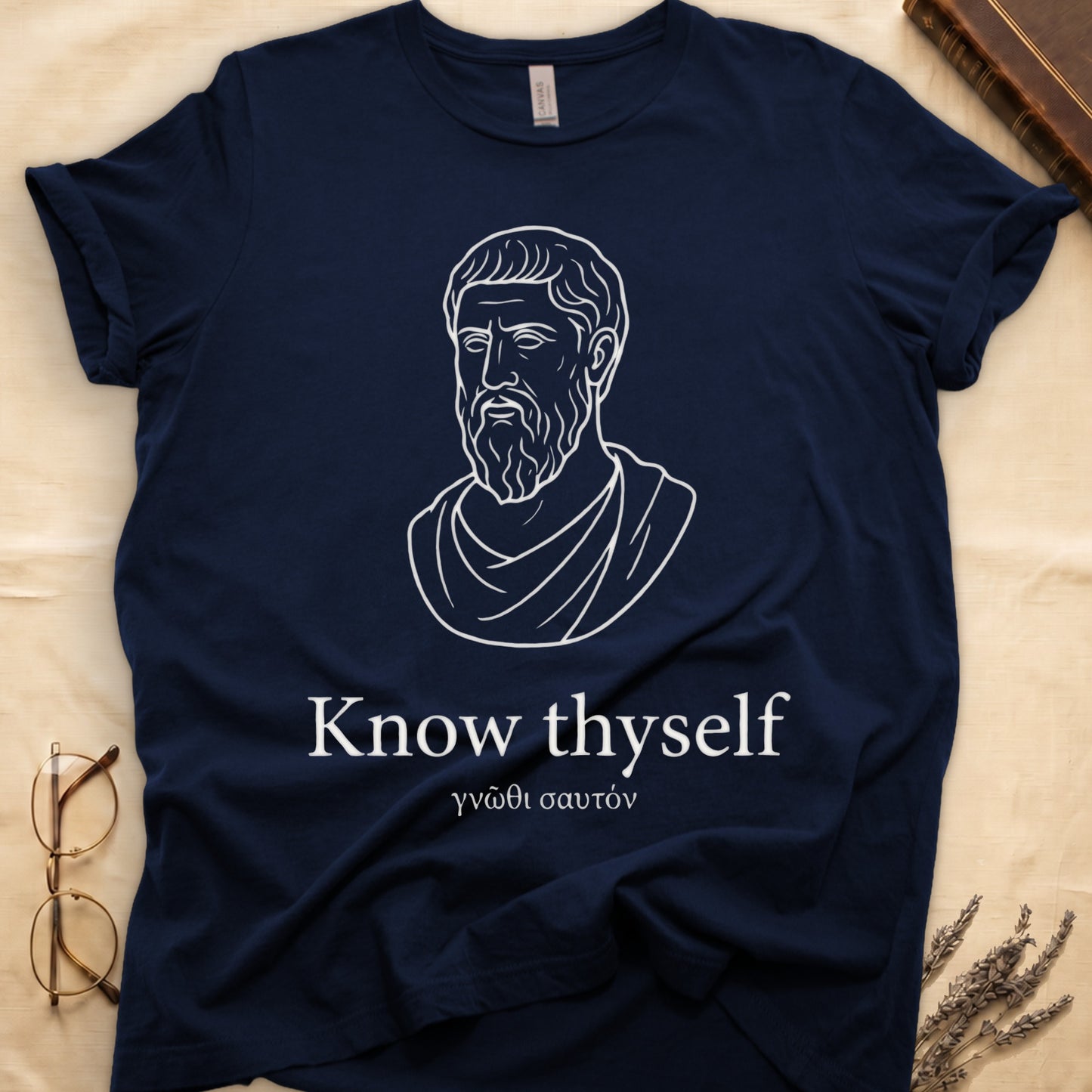 Navy tee with classical Greek philosopher bust in white linework, "Know thyself" in cream serif below.