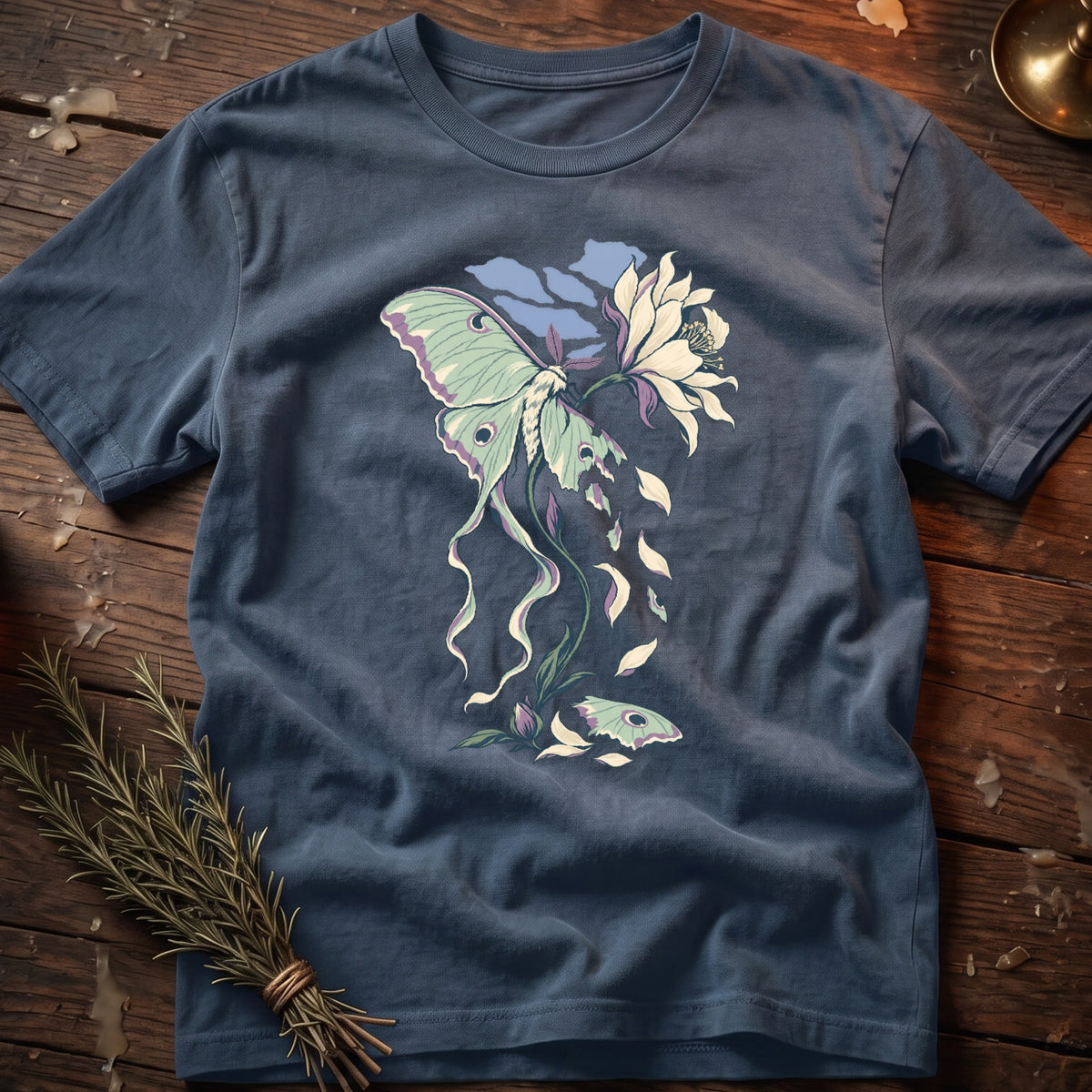 Blue t-shirt with a luna moth and flower graphic.