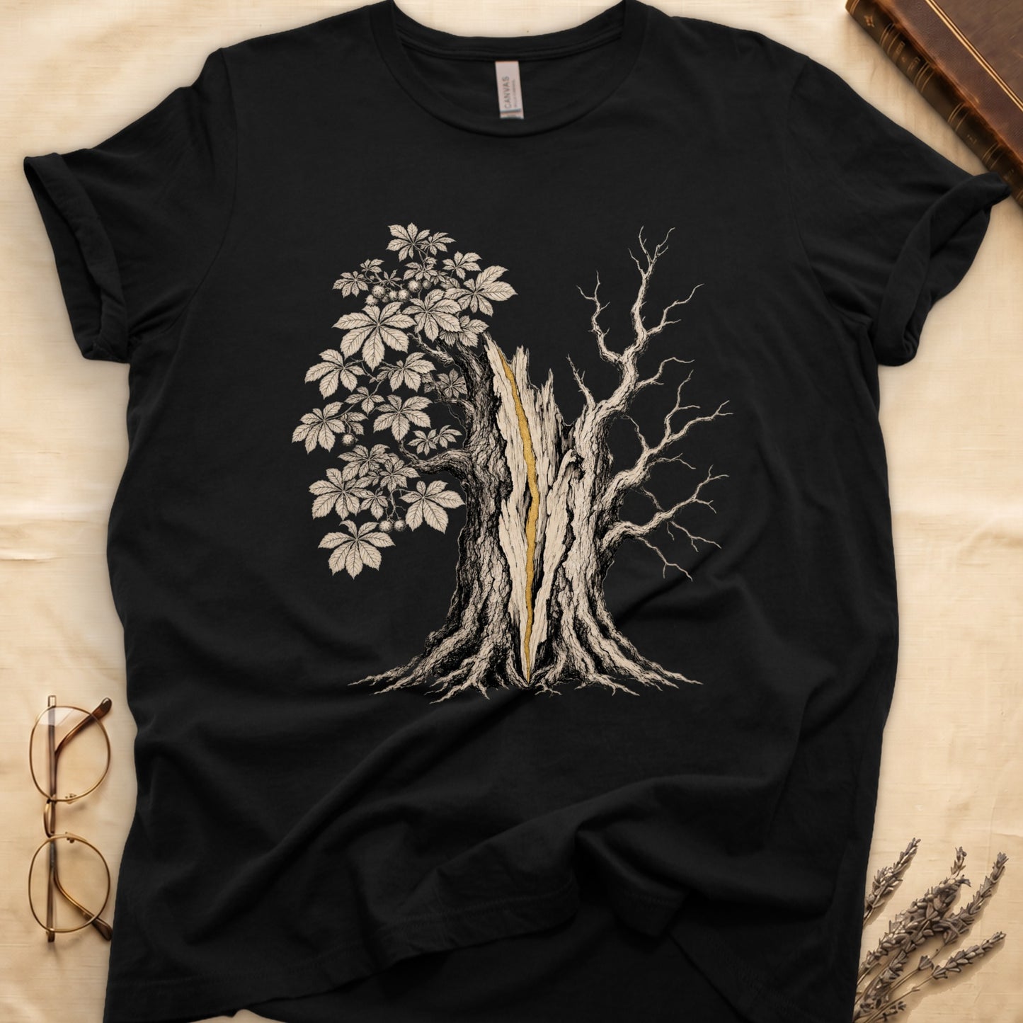 Black t-shirt featuring a split tree graphic with leaves on one side and bare branches on the other.