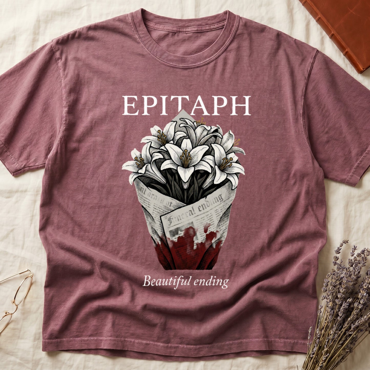 Dark Rose tee with "EPITAPH" over crosshatched white lilies in blood-stained newsprint wrap, "Beautiful ending" italic serif.