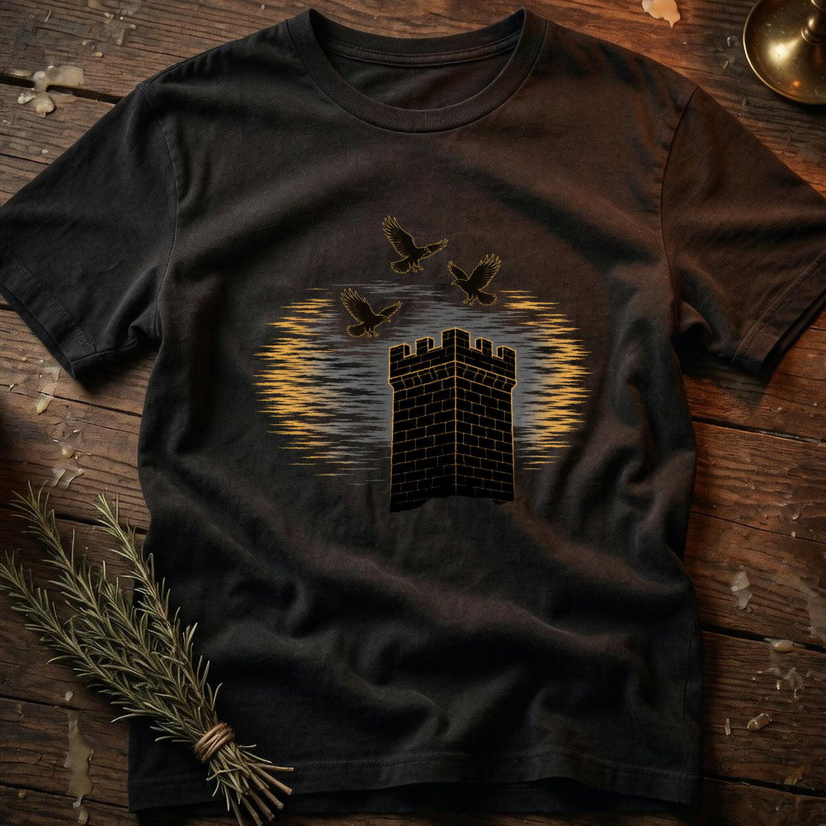 Black t-shirt with a brick tower and three birds against a sunset background.