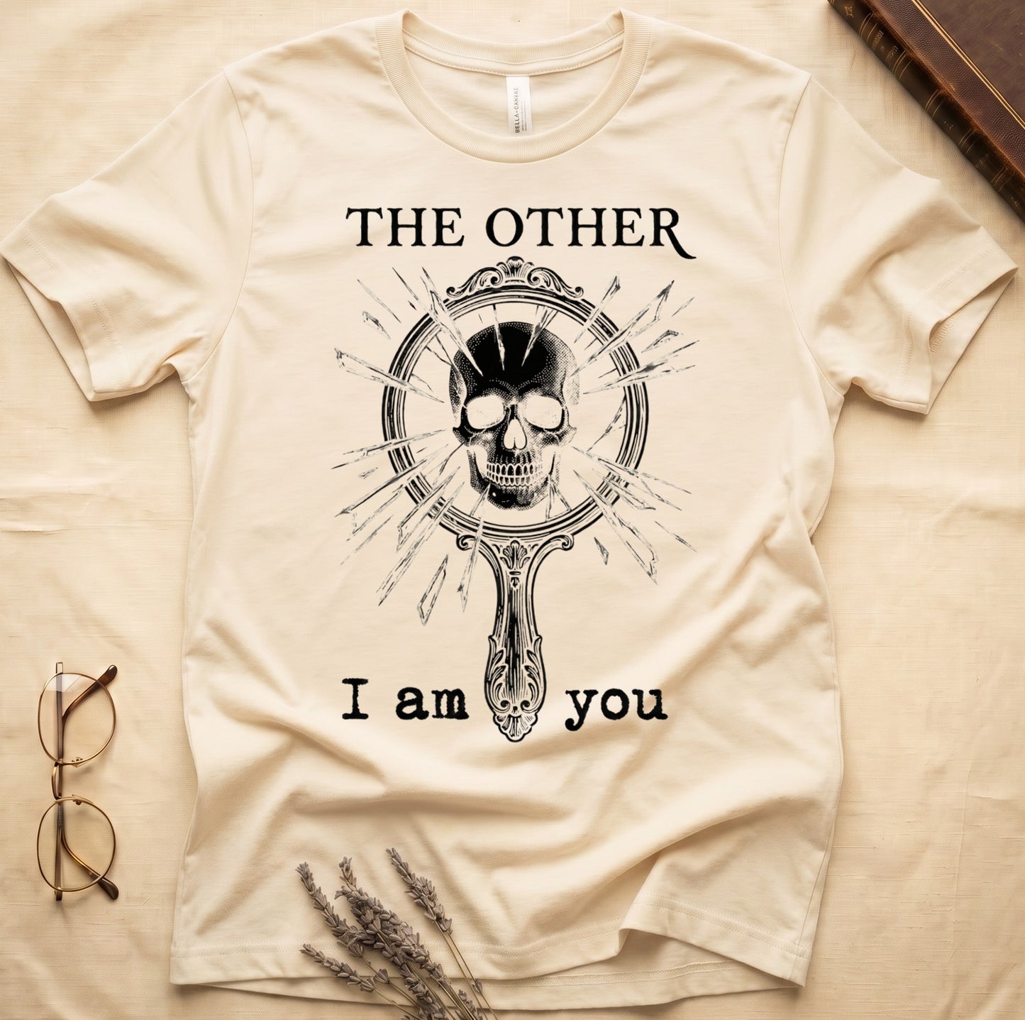 Natural tee with shattered mirror and skull emerging in cream linework, "THE OTHER" top, "I am you" below.