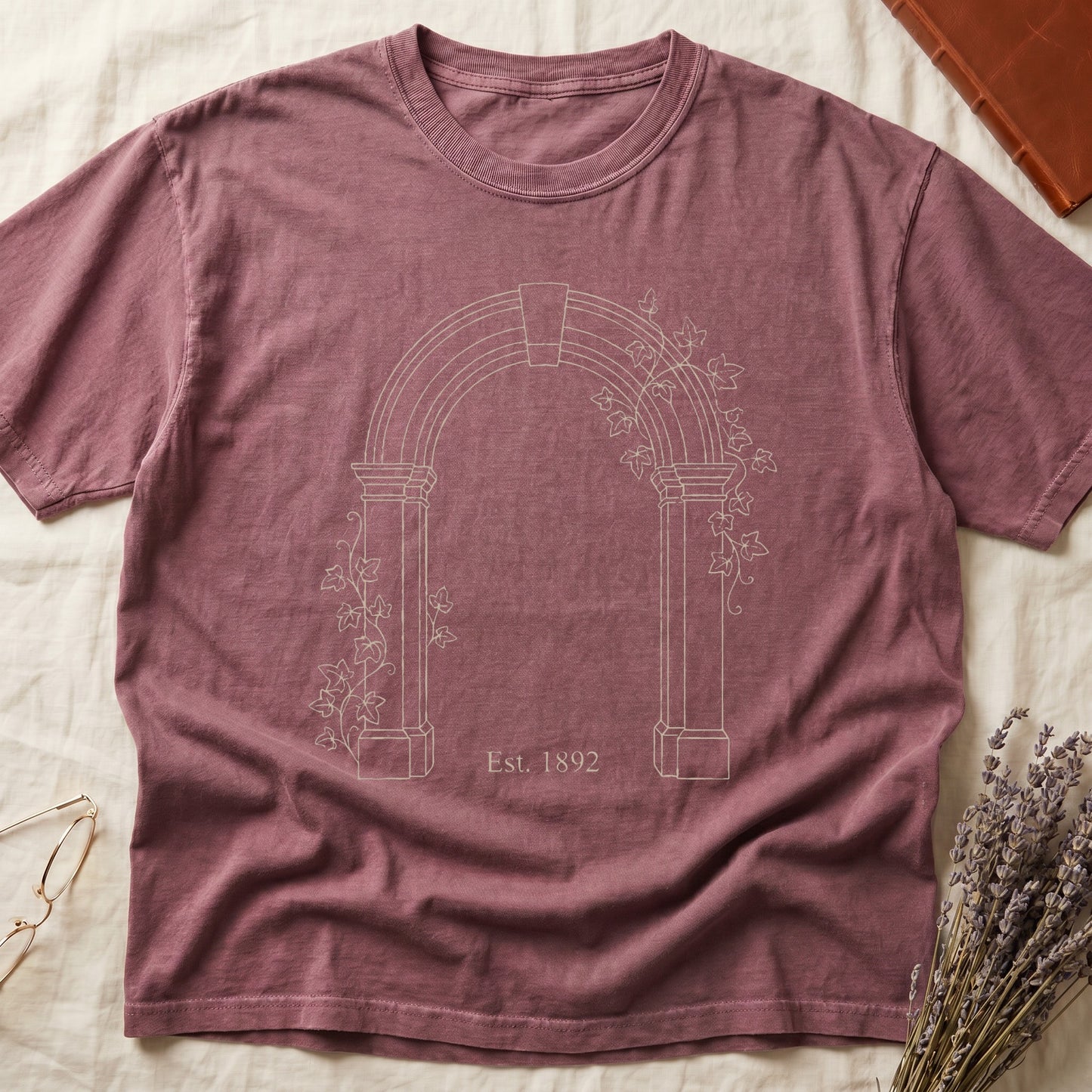 Dark Rose tee with Gothic stone archway in cream linework, ivy climbing the columns, "Est. 1892" inscribed at the base.
