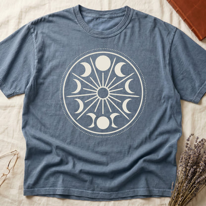 Blue Jean tee with cream lunar orrery wheel, dotted ring, radial sunburst, moon phases around perimeter, central star.