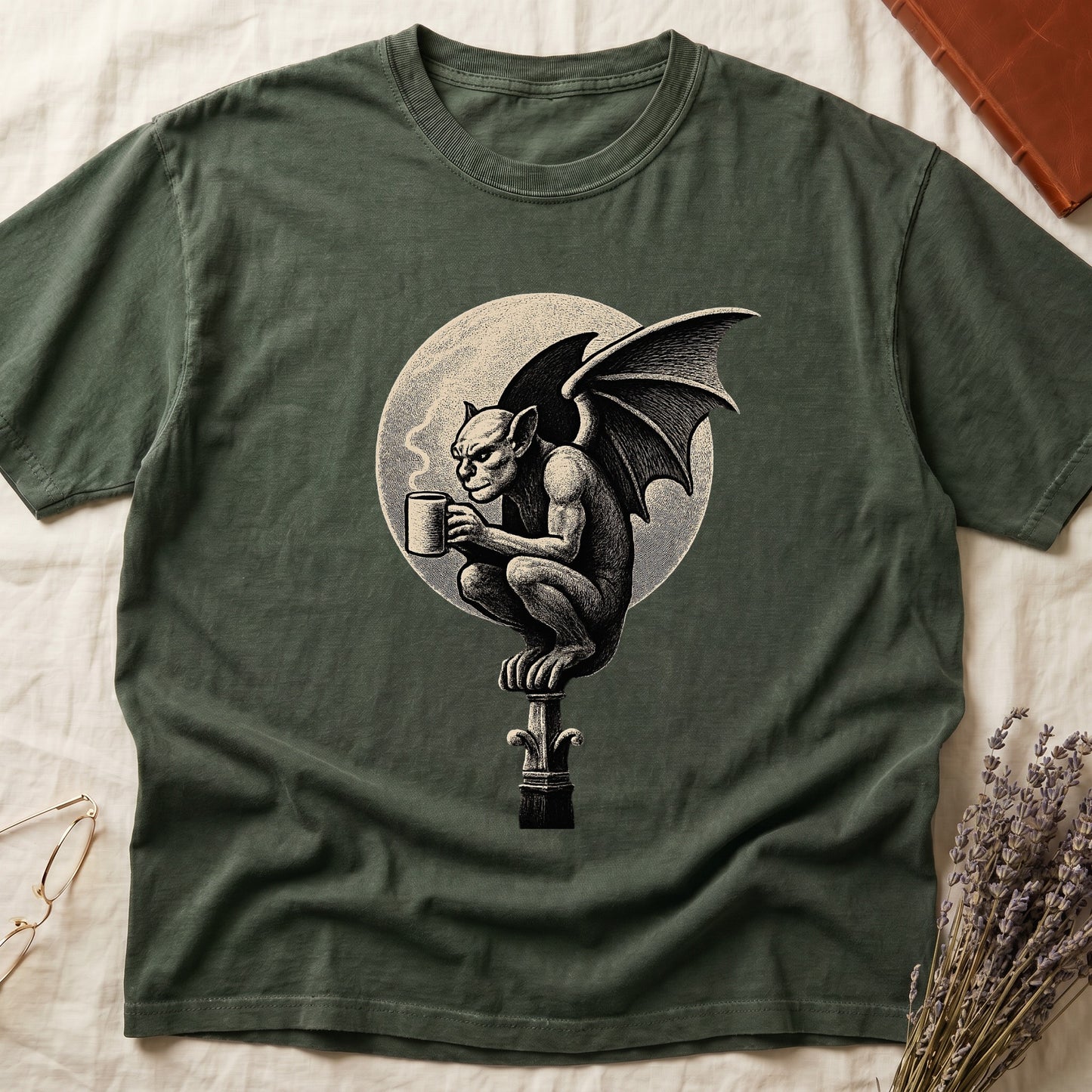 Green tee with gargoyle on stone pinnacle holding coffee mug, cream-parchment full moon behind, engraving style.
