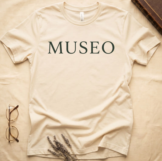 Natural tee with "MUSEO" in oversized cream serif capitals, minimalist typographic design.