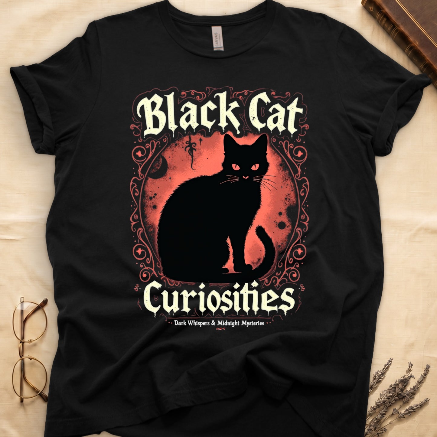 Black tee with black cat, red eyes, red-orange moon, "Black Cat Curiosities," "Dark Whispers & Midnight Mysteries."